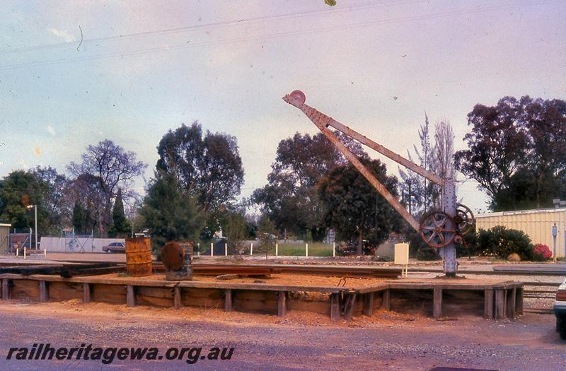 P21055
Loading platform, platform crane. Pinjarra, SWR line, rear and view, note the 44 gallon drums on the platform
