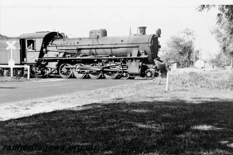 P21093
W class loco hauling goods train through level crossing, near Vasse River bridge, WN line, side view
