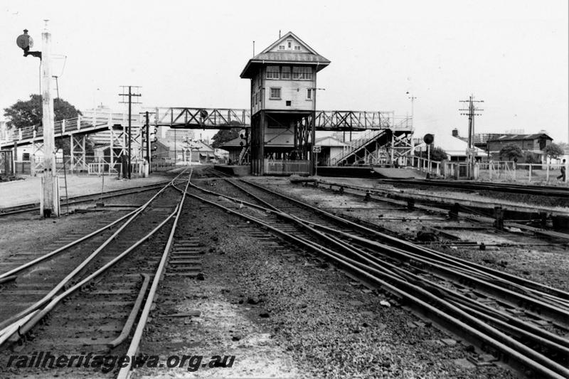 P21129
Signal box, signals, track, points, platforms, station buildings, canopies, overhead footbridge, East Perth, ER Line, view from track level 
