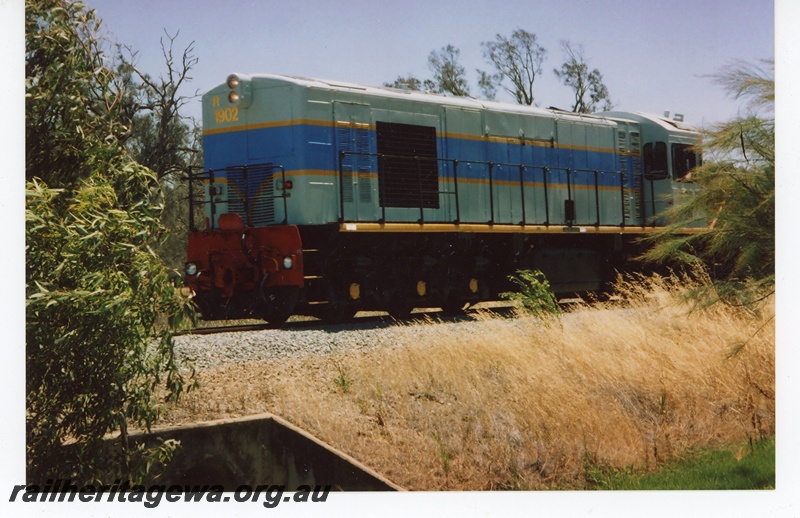 P21209
R class 1902 in South Spur Rail light and dark blue livery with yellow stripe, crossing culvert near Serpentine, SWR line, end and side view
