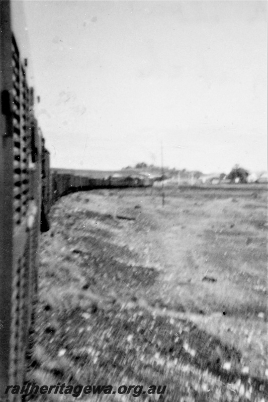 P21215
Mixed train, pulling up the rise out of Cue, NR line, view looking back along the train 
