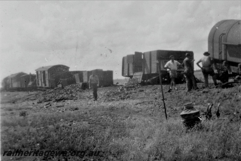 P21218
Derailment on Wiluna line 3 of 7, van, wagons, workers, manganese ore spilled from wagons, NR line, trackside view
