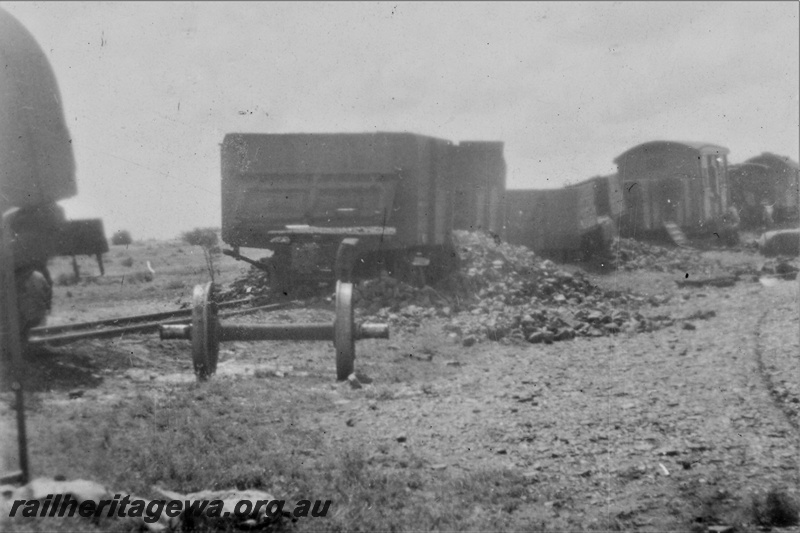 P21221
Derailment on Wiluna line 6 of 7, manganese ore spilt from wagons, vans, axle wheels, GN line, trackside view
