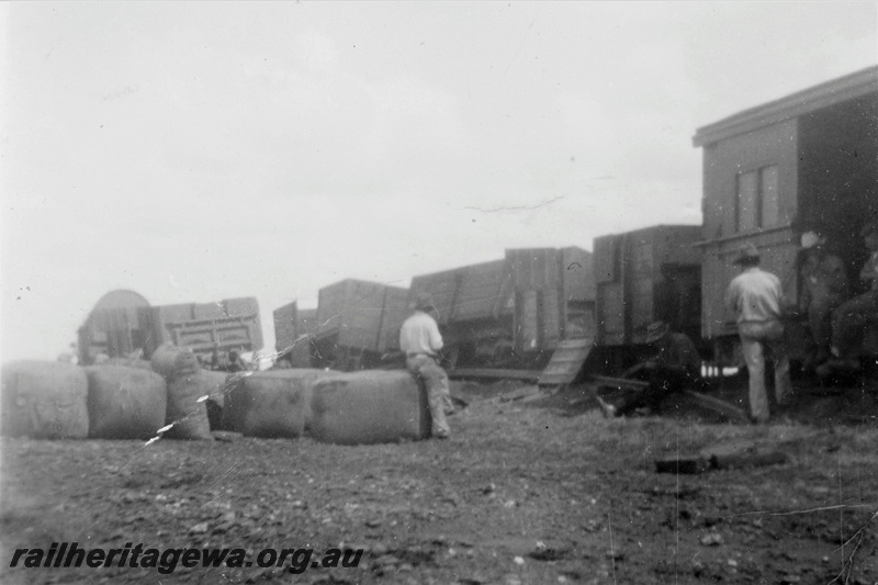 P21231
Goods train loading, van, wagon, bales, workers, GN line, view from trackside
