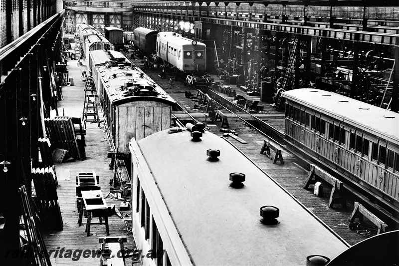 P21259
ADE class Governor railcar in final stages of fitting out, several carriages under repair, various machinery, in the Carriage Shop, Midland Workshops, ER line, overview from elevated position, c1937
