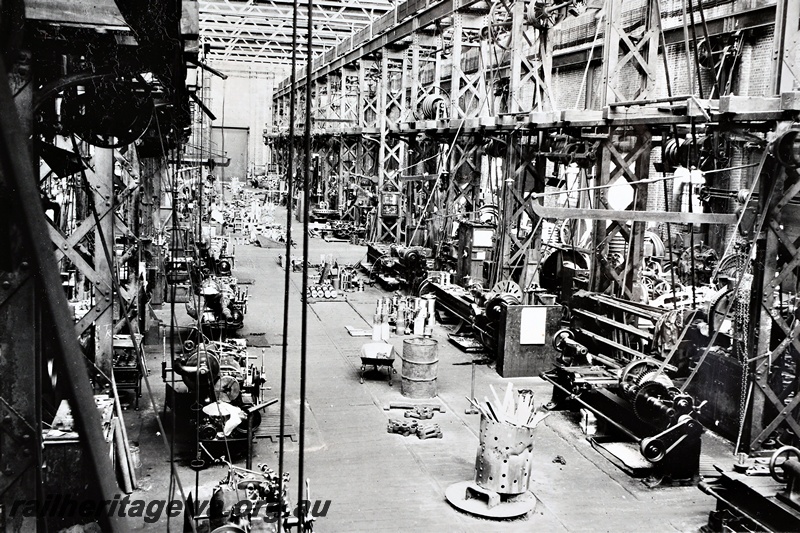 P21263
Interior view of the Machine Shop, line shafting, belt driven machinery, Midland Workshops, ER line, general view from elevated position, c1937
