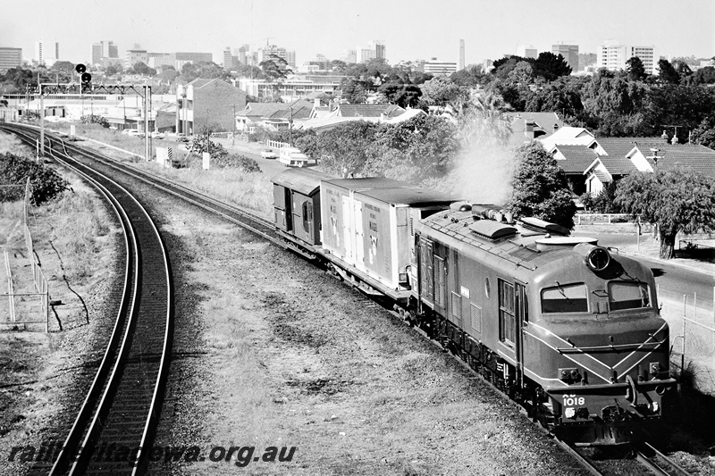 P21291
XB class 1018 on two car train, signal gantry, houses and city in background, Mount Lawley, ER line, side and front view from an elevated position
