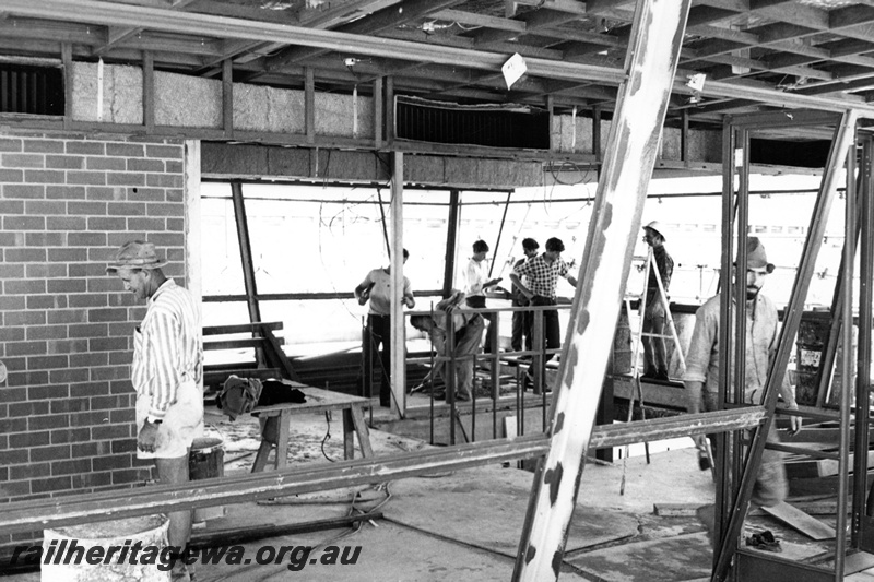 P21330
3 of 3 views of the construction of yardmaster's office and control Tower, at Leighton ,internal view of the control room with workers and the dividing brick wall. 
