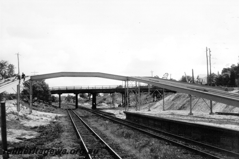 P21333
Overpass under construction, workers, platform, tracks, existing overpass, in preparation for the standard Gauge, Sucess Hill, ER line, view from track level 

