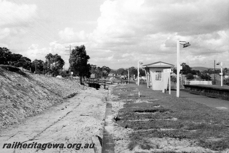 P21334
Station shelter,new track bed, platforms, station lamps, station nameboard, tracks, view from platform level, Success Hill, in preparation for the standard Gauge
