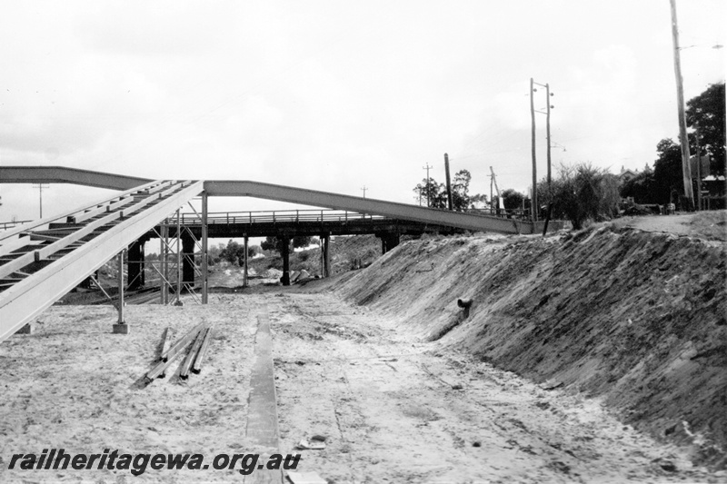 P21335
Overpass under construction, platform, track bed, existing overpass in preparation for the Standard Gauge, Success Hill,  view from track level 
