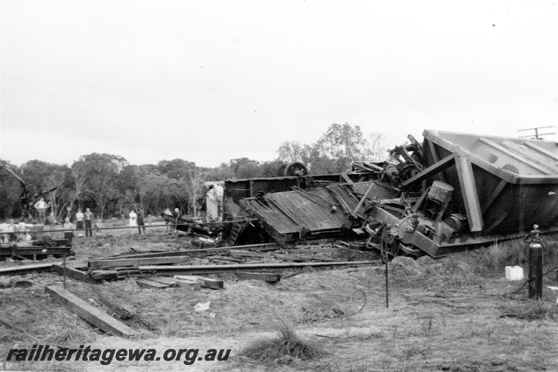 P21336
Scene of derailment, tracks torn up, wagons damaged, onlookers, Mundijong, SWR line, trackside view

