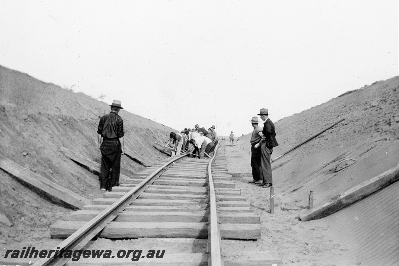 P21361
Track laying, rails on sleepers, cutting, workers, supervisors, Indarra deviation, NR line, trackside view, c1936
