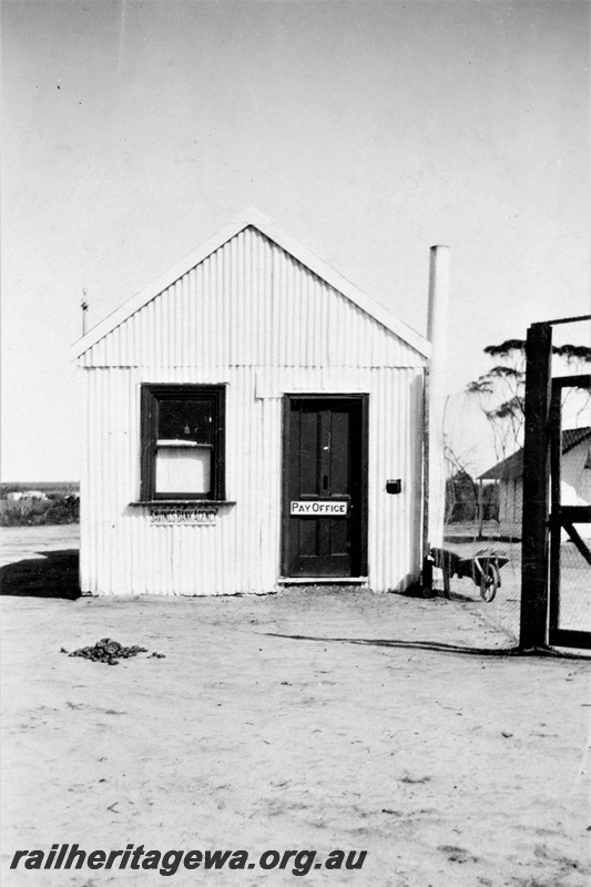 P21363
Pay office and savings bank agency building, wheel barrow, permanent way camp, Indarra deviation, front view, c1936
