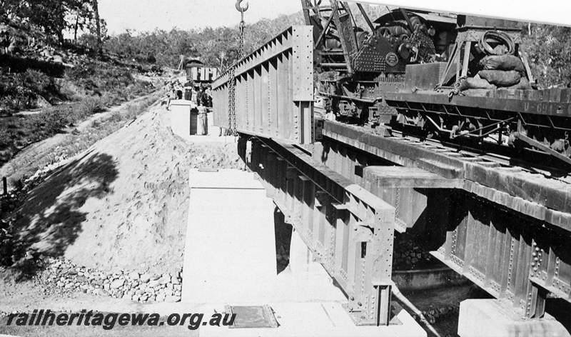 P21367
Construction of new bridge, concrete and steel, new span being lifted into place, mobile crane, workers, near National Park, Eastern Railway duplication, ER line, c1927
