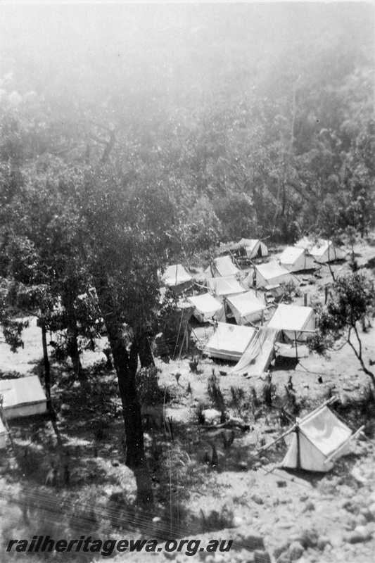 P21372
Permanent way camp, multiple tents in bush setting, Eastern Railway duplication, Parkerville, ER line, view from elevated position, c1932-1934
