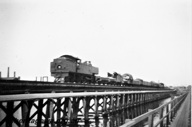P21387
D class loco on goods train crossing wooden trestle Bunbury Bridge, pedestrian walkway, Perth, SWR line, rear and side view
