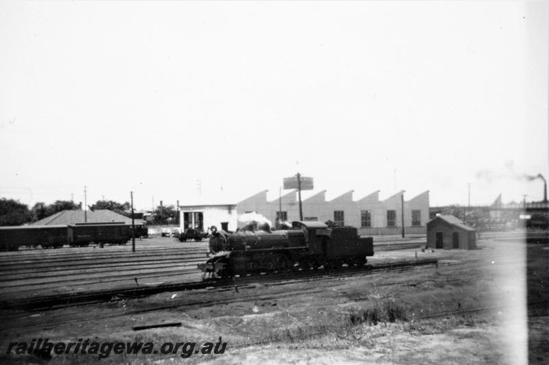 P21407
PR class loco, sidings, buildings, wagons, East Perth depot, ER line, front and side view
