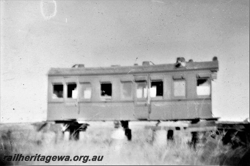 P21423
APC class 154, in derelict condition, without wheels, chocked up on drums, Port Hedland, PM line, side view
