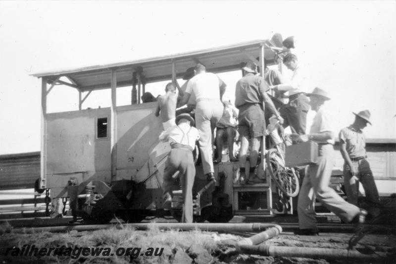 P21425
Mechanised trolley, being boarded by workers, Derby, side and end view
