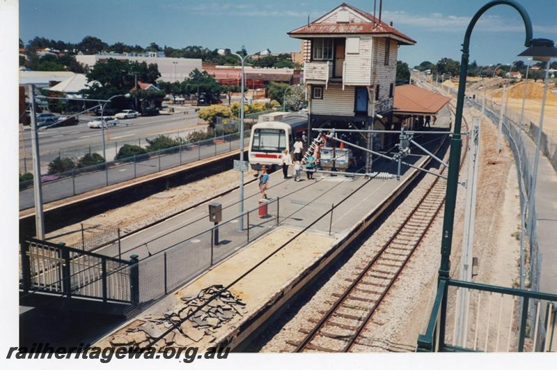 P21433
EMU A series set with the red stripe above the side windows, standing at platform during Subiaco Centro project, signal box, station building, catenary poles, Subiaco, ER line, 

