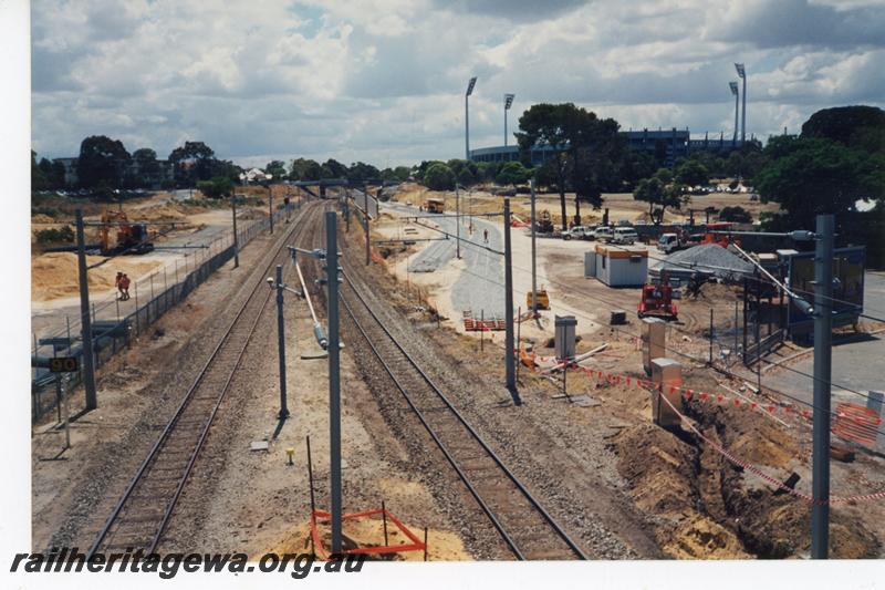 P21434
Tracks, catenary poles, construction works during Subiaco Centro project, Subiaco Oval in background, Subiaco, ER line, view from elevated position
