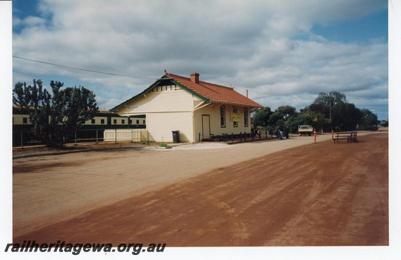 P21441
Station building, Hotham Valley Railway excursion train standing at station, Mukinbudin, WLB line, view from road passing the station
