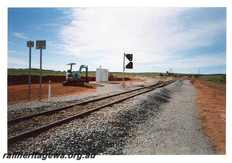 P21444
Turnout, track, signals, mechanical excavator, trackside shed, signs, Ruvidini Junction, NR, track level view
