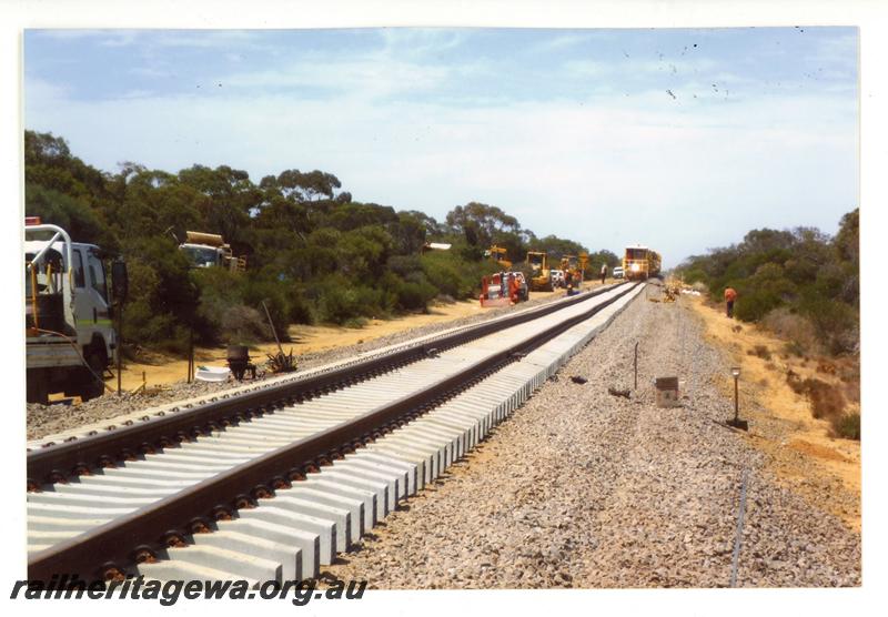 P21446
New track laid on concrete sleepers, awaiting ballast, various track laying machinery, west of Tenindewa, NR line, trackside view
