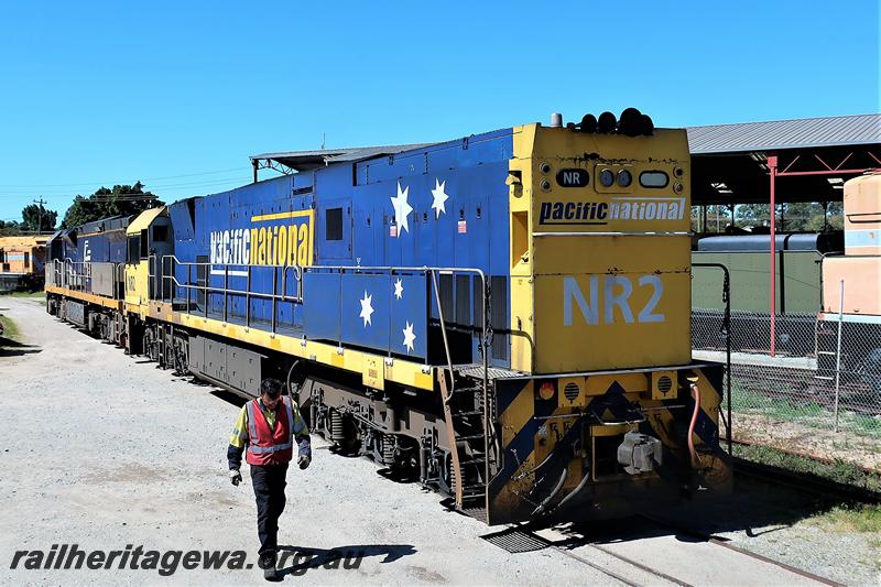P21538
Pacific National loco, NR class 2 in the yellow and blue livery passing through the site of the Rail Tansport Museum en route to the plant of UGL, side and end view
