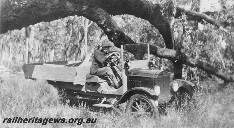 P21559
20 of 20 Construction Scenes of Third Beechina Deviation between Wooroloo and Chidlow ER line c1920s, truck and driver in the bush under tree branch, 