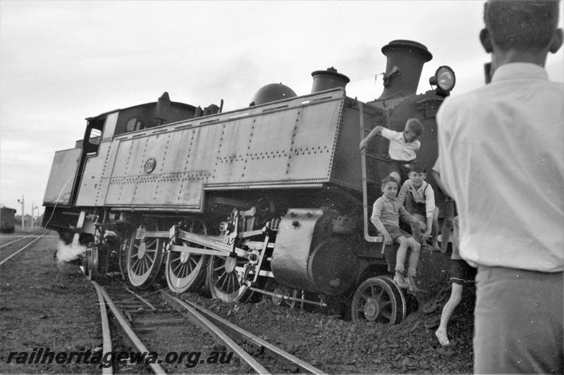 P21591
DM class 585 on No. 253 Passenger, derailed at Midland Junction, ER line,  boys climbing on front of loco, adult with back to camera, signals, tracks, side and front view. Date of derailment 30/10/1953
