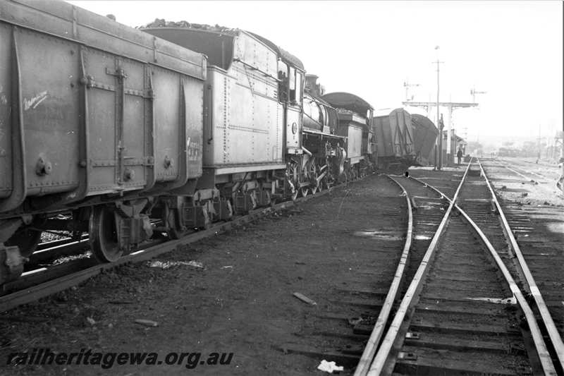 P21604
Collision scene, side views of KW class wagon 10795, PR class 532, ES class 339, derailed vans, bracket signals, points, onlooker, Spencers Brook, GSR line, view from trackside
