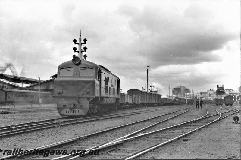 P21616
X class 1004, on goods train, van, carriages, wagon, shed, points, sidings, workers, signals, Perth yard, ER line, track level view
