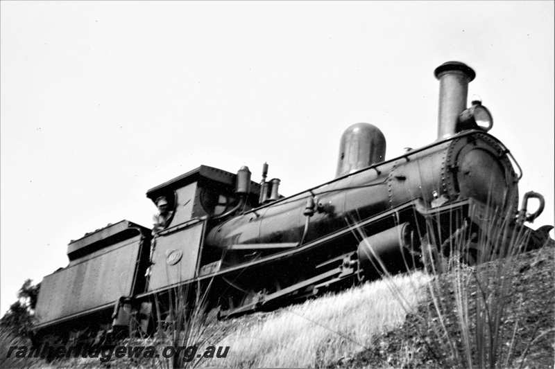 P21620
G class 107 with driver Gordon McIntyre looking out of the cab, UDDR line,  side and front view looking up at the loco
