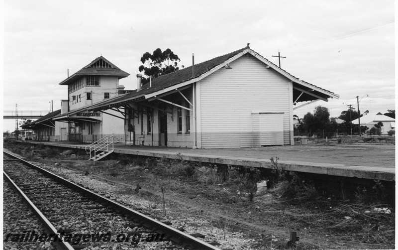 P21691
Station buildings, platform, signal box, overhead footbridge, pedestrian crossing and steps to platform, track, Merredin, EGR line, view along platform from track level
