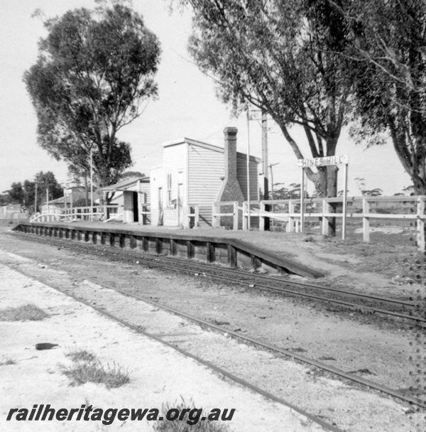 P21832
Platform, station buildings with brick chimney, station sign, tracks, Hines Hill, EGR line, view from track level
