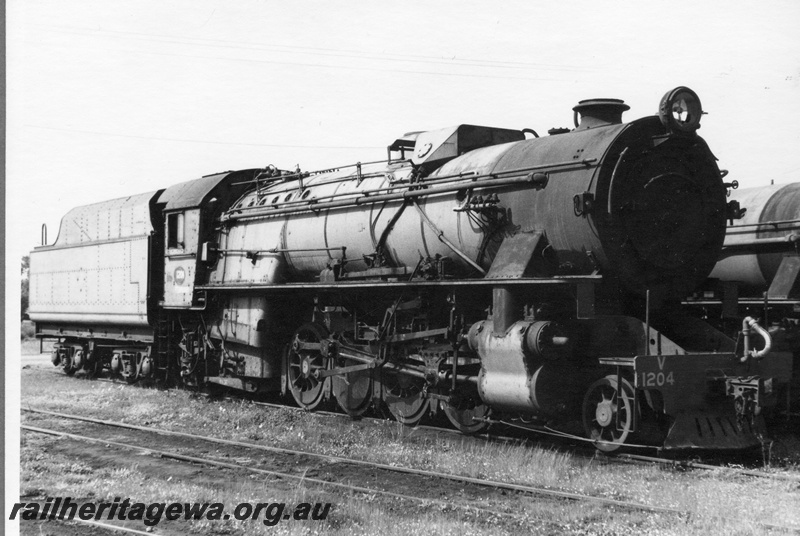P21901
V class 1204, on scrap road, loco depot, Collie, BN line, side and front view
