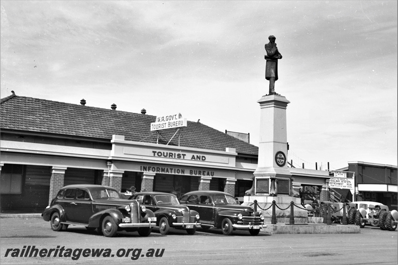 P21922
Statue of C Y O'Connor, WA Govt Tourist Bureau Tourist and Information Bureau building, taxi cab, cars, near D Shed, Fremantle, ER line, view from carpark
