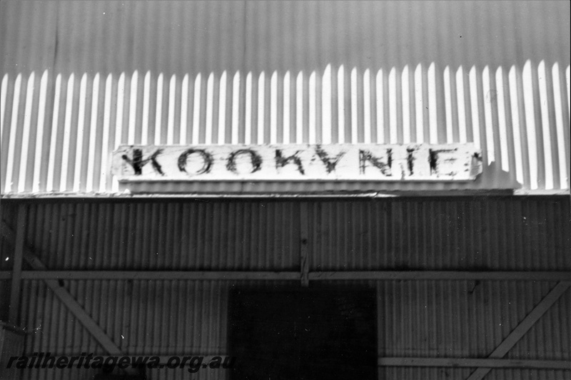 P21998
Nameboard, Kookynie, KL line, mounted on the front edge of the roof of the station building
