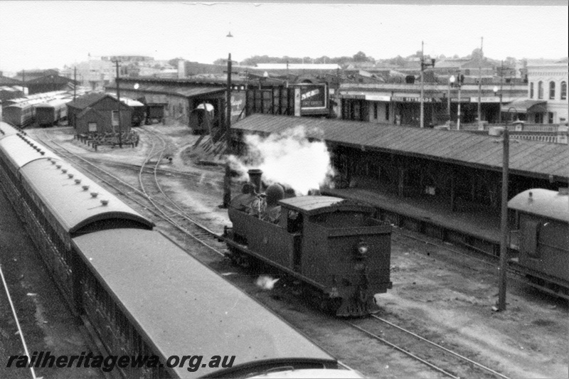 P22014
N class 71, carriage shed, platform, canopy, carriages, tracks, view looking towards Perth, side and rear view of loco from elevated position
