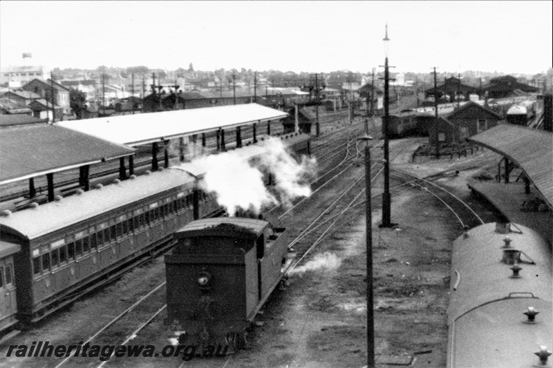 P22015
N class 71, platforms, canopies, rakes of carriages, carriage shed, tracks, view looking towards Perth, rear and side view of loco from elevated position
