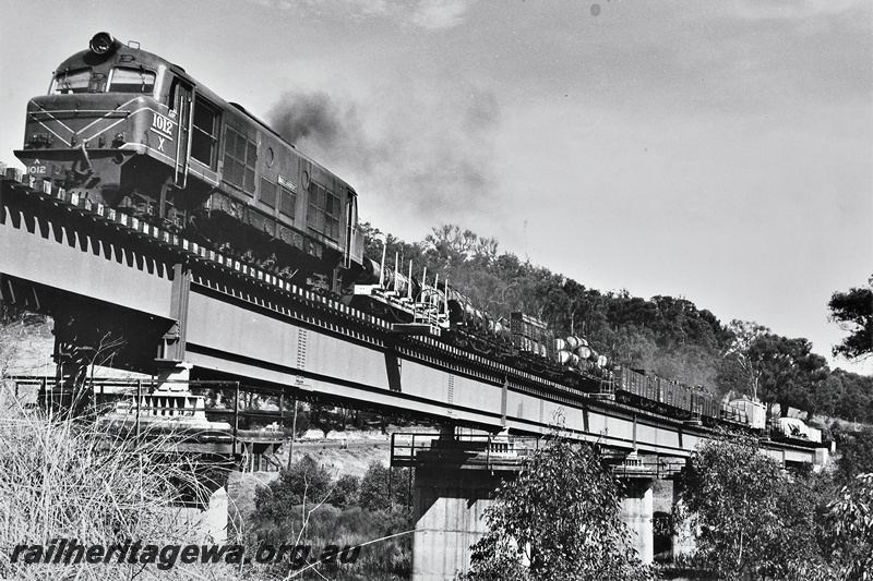 P22031
X Class 1012, on goods train, Bridgetown, crossing steel and concrete bridge, front and side view from below bridge, PP line
