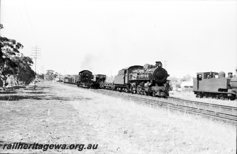 P22073
PMR class 727 hauling a Perth bound goods passing K class 102 in East Perth loco depot siding and DD light engine. ER line.
