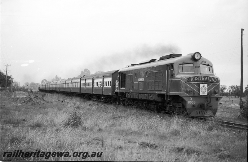 P22088
X Class 1005 hauling  Australind with headboard and crest near Serpentine. SWR line.
