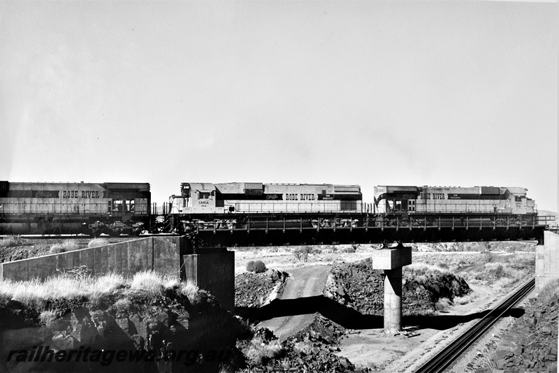 P22200
Cliffs Robe River diesels numbered 9413, 9418 and another, on a concrete and steel bridge, crossing over Hamersley Iron's Paraburdoo to Dampier line, 47 miles from Dampier, Pilbara, side view
