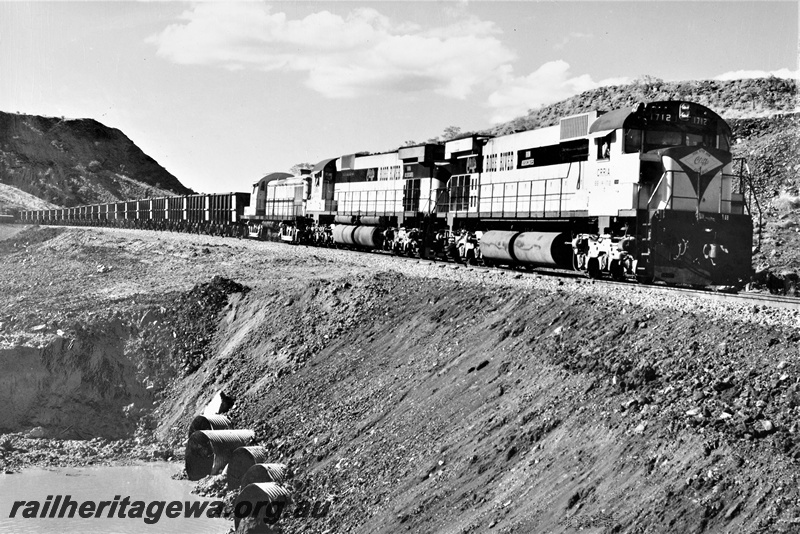 P22201
Cliffs Robe River diesels numbered 1712,1710 and 1705 (formerly NSWGR 40 class), triple heading loaded iron ore train to Cape Lambert, crossing culvert, Pilbara, side and front view

