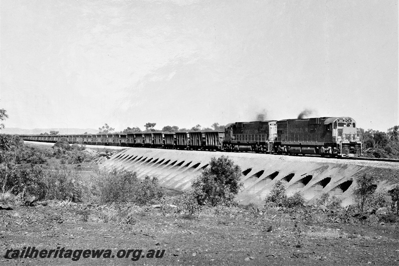 P22210
Hamersley Iron diesels numbered 2012 and 2011, double heading iron ore train, crossing Fortescue River culvert, Pilbara, side and front view
