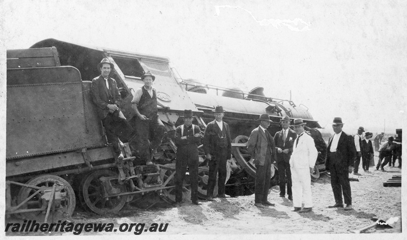 P22258
Derailment at169 mile near Bruce Rock YB line No 1 of 7, L class 240 running tender first derailed, onlookers, rear and side view
