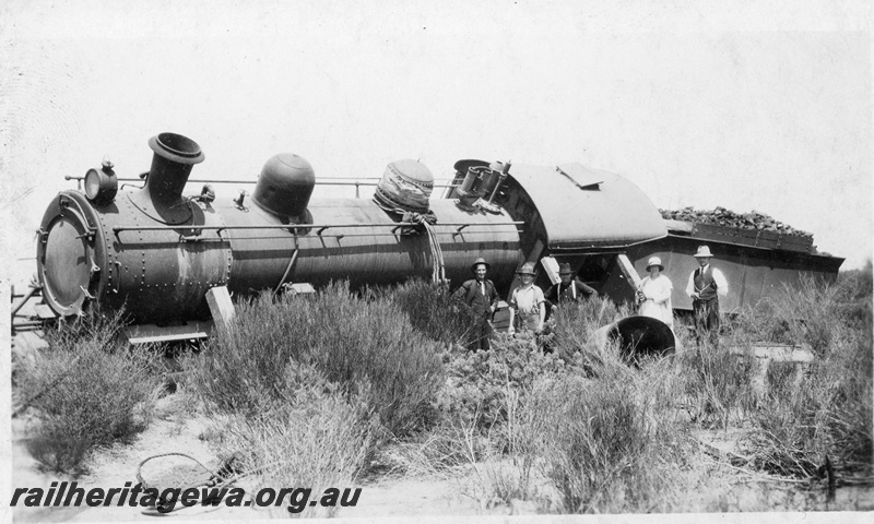 P22259
Derailment at169 mile near Bruce Rock YB line No 2 of 7, L class 240 running tender first derailed, onlookers, front and side view
